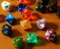 Dice of different shapes and colors.